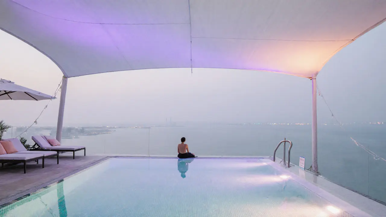 Cielo rooftop infinity pool reflecting pastel lights under a glowing white canopy, serene night atmosphere.